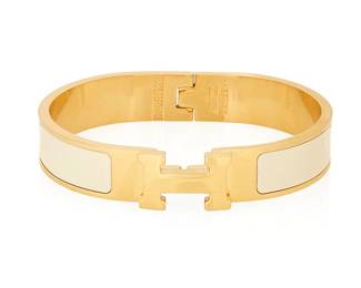 1145
Hermès: An Enamel "Clic H" Bracelet, 2013
A yellow gold-plated narrow bangle in plain white enamel, with "H" swivel toggle clasp, marked verso for France, maker, and date
Inner circumference: 6 1/2 in. x 1/2 in. H
35.8 grams gross
Estimate: $250 - $350