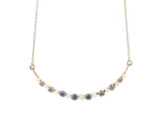 1031
A 14K Bi-Color Gold, Sapphire and Cultured Pearl Necklace
Featuring an antique crescent brooch converted to a pendant set with alternating cultured pearls and round sapphires finished with a white gold chain
Length: 18 in.
4.28 grams gross
Estimate: $400 - $600