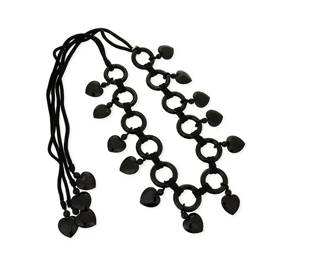 1148
Yves Saint Laurent: A Vintage Rive Gauche Black Acrylic Heart Link Belt
Featuring multiple "faux-jet" black resin circular links suspending faceted heart dangles, all joined with black cording and closed with black cord ties with heart dangle ends, with stamped hang tag: Rive Gauche / Made in France
Measures: 27 in.; with ties: 70 in. approximately
328.3 grams gross
Estimate: $200 - $300