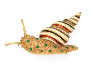 1001
An 18K Gold and Enamel Snail Brooch
Of a textured design featuring red, black and white striped enamel on the shell accented by round emerald cabochons, signed Italy
Measures: 2 1/2 in.
20.0 grams gross
Estimate: $1,000 - $2,000