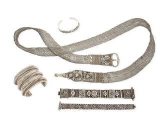 1190
A Group of Sterling Silver and Mixed Metal Jewelry
Five works comprising two Southwest-style sterling silver cuffs, together with two Rajasthani-style Indian sterling silver link bracelets, and a similar style Indian silver metal link double-length belt, one cuff marked: 925
5 pieces
Belt: 49 1/4 in. x 1 3/4 in.; Cuffs: 6 1/4in. inner C x 2 1/4 in. & 7 in. inner C x 3/8 in.; Links: 8 in. long
747.7 grams gross
Estimate: $200 - $400