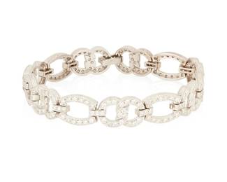 1063
An 18K White Gold and Diamond Bracelet
Featuring open and infinity style links set with round diamonds weighing approximately 3.00 carats
Length: 7 in., Width: 3/8 in.
22.3 grams gross
Estimate: $1,500 - $2,000