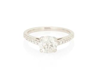 1062
A 18K White Gold and Diamond Ring
Centering a round diamond weighing approximately 1.15 carats, accented by round diamonds down half the shank
Size: 5 1/2
3.3 grams gross
Estimate: $800 - $1,200