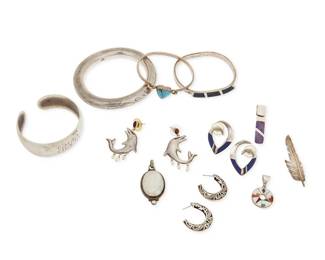 1184
A Group of Sterling Silver Jewelry
Comprising three bangle bracelets, two with set stones, and a vintage S. Kirk & Son monogrammed cuff, together with four pendants, three with set stones, including one with a moonstone cabochon, as well as a silver feather pendant/brooch, and three pairs of earrings including a pair with silver and lapis coral and turquoise inlay, and a pair of sterling dolphin earrings with pearl dangles
14 pieces
Bangles: 7 1/2 - 6 1/2 in. inner C; Pendants: 2 1/4 - 1 1/4 in; Earrings: 1 3/4 - 1 1/8 in.
177.0 grams gross
Estimate: $700 - $900