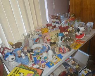 3 tables of snoopy collectibles. Upper den