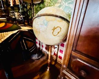Vintage Replogle World Classic Series globe, characterized by its antique-ocean coloration and raised relief details on wood ( walnut ) stand. 