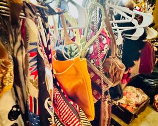 Racks of handbags, purses, backpacks, carry on, kilim, ethnic, designer. This is just one rack full of purses. 