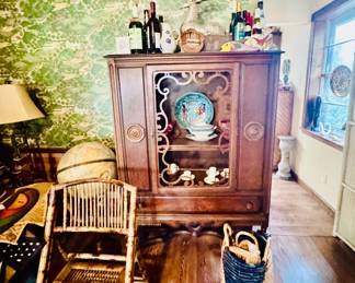 antique china hutch or cabinet, likely from the 1920s. 
It exhibits Art Nouveau styling, features details like scrolled wood, open door panels, and marquetry.