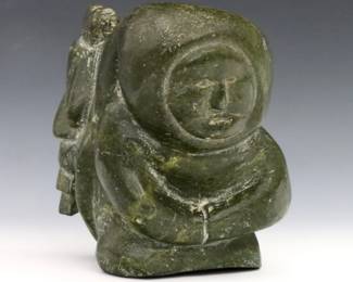 A 20th century Inuit carved Serpentine figure of a mother with a child at her back. Minor surface wear. 5 1/2" high. ESTIMATE $200-400