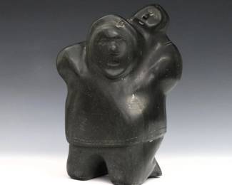Joe Emiqutailaq, Inuit (Belcher Islands), b. 1918. A 20th century carved stone figure of a mother with a child at her back. Signed in syllabics with "E9-85" at underside. Minor wear. 7 3/4" high. ESTIMATE $200-400