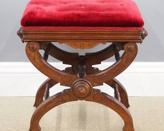 A 19th century Victorian Eastlake Period piano seat. Walnut construction with "X" form legs which raise or lower by turning the knobs on either end of the seat, carved detail on the skirt and legs with a Red velvet seat. Original paper label reads "The X Piano Tabouret, L. Postawka & Co." in Cambridge, Mass, patented in 1871. Older finish with minor wear. 14 1/2 x 22 x up to 21" high overall. ESTIMATE $200-300