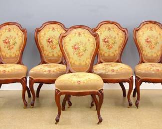 Five 19th century Victorian Rococo Transitional parlor sidechairs. Walnut construction with shaped solid backs, needlepoint seats and back panels on cabriole legs. Older finish with some wear, upholstery quit worn. Each 18 x 18 x 36 1/2" high overall. ESTIMATE $400-600