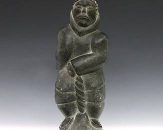 Daniel Oweetaluktuk, Inuit (Inukjuak), b. 1934. A 20th century carved Soapstone figure of a hunter gripping the horn of a narwhal with polished finish. Signed in syllabics with "E9 1702" disc number. Minor surface wear. 11 1/4" high. ESTIMATE $300-500
