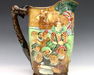 A 1930's Royal Doulton porcelain "Drake" jug designed by Charles Noke and Harry Fenton. Molded scenic design commemorating Francis Drake with a ship "rope" themed handle and multicolor glaze. Printed "Royal Doulton" mark with edition "no. 264" of 500 at underside, molded "Noke" and "Fenton" signatures at handle near base. Includes original signed paperwork. Some crazing. 10 1/2" high. ESTIMATE $200-400