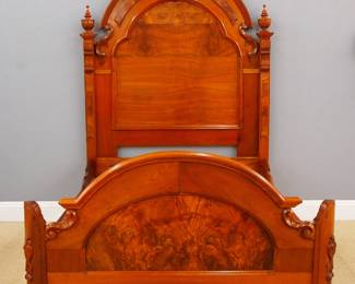A 19th century Victorian Renaissance Revival Period bed. Walnut construction with inset Burl panels and carved detail, curved footboard with carved medallion. Refinished, replaced panel in headboard and finials. 62 x 80 x 95 1/2" high overall. ESTIMATE $300-500