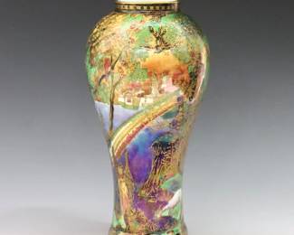 An early 20th century Wedgwood Fairyland Lustre vase designed by Daisy Makeig-Jones. Shape #2046, baluster porcelain form with polychrome "Rainbow/Bifrost" decoration and Gilded detail. Illustrated Plate 25 "Wedgwood Fairyland Lustre" U. Des Fontaines, Barrie & Jenkins, London, 1975, p. 127. Printed "Wedgwood / Made in England" mark, with "Z4968 A" and "2046". Minor wear to Gilded decoration, lacks cover, hairlines at foot. 7 3/4" high. ESTIMATE $400-600