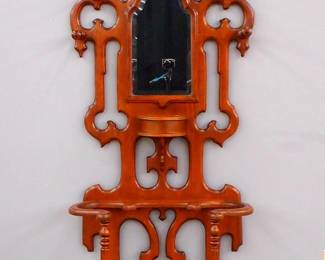 A 19th century Victorian Renaissance Revival Period hall rack. Walnut construction with a shaped cutout back, turned coat pegs, inset beveled mirror and a small hinged box over lower umbrella arms and fancy Cast Iron drip pan. Refinished with minor wear, some older repairs. 32 1/2 x 14 x 91 1/2" high overall. ESTIMATE $300-500