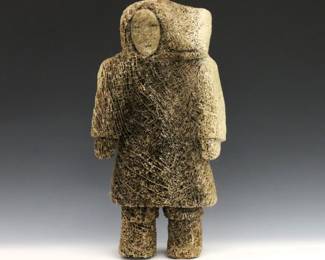 A 20th century Inuit carved Whale bone figure of a woman from the Pangnirtung hamlet, Qikiqtaaluk Region, Canada. Retains original "Eskimo" art tag citing artist as "J. Kobee" (n.d.). Minor wear. 14" high. ESTIMATE $300-400
