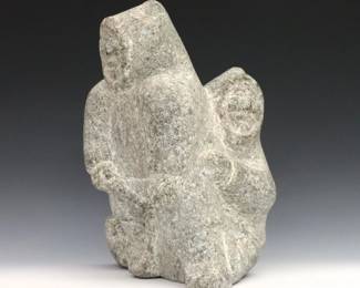 Attributed to Ningiuq Kiatainaq, Inuit (Wakeham Bay/Kangiqsujuaq), b. 1918. A 20th century carved stone figure of a mother with a child at her back. Unsigned, retains original "Canadian Eskimo Art" Igloo tag citing artist as "Ningiuq". Minor wear. 10 x 7 x 12 1/4" high overall. ESTIMATE $400-600