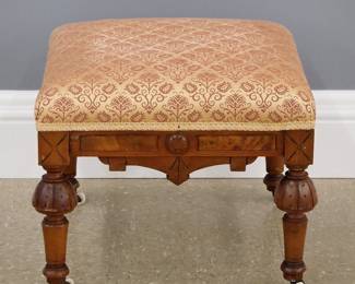 A 19th century Victorian Eastlake Period footstool. Walnut construction with turned legs united by shaped skirts, upholstered seat. Minor wear. 18 x 18 x 14 1/2" high overall. Estimate $100-150