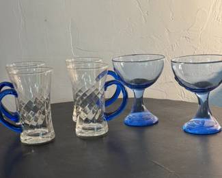 Four Mugs with Blue Handles and Two Goblets