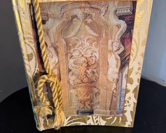 Hardcover Book with Rope Bookmark and Statue Depiction