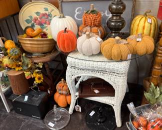 Wicker end table, fall pumpkins, copper pans, decor