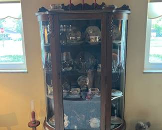 Bow front china cabinet with china, glassware