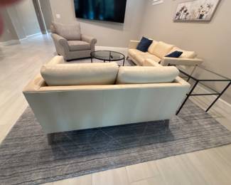 cream colored leather loveseat 16” x 55” x 33”-$375 cream colored leather sofa 16” x 80” x 34” -$475 Extra large grey armchair 18 x 46 x 41-$325