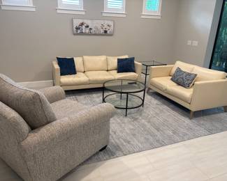 cream colored leather loveseat 16” x 55” x 33”-$375 cream colored leather sofa 16” x 80” x 34” -$475 Extra large grey armchair 18 x 46 x 41-$325