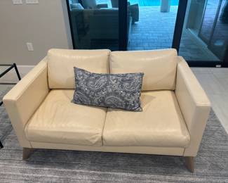 cream colored leather loveseat 16” x 55” x 33”-$350