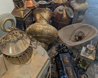 Large collection of lamps and lanterns available for sale.