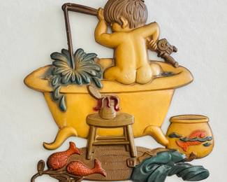 This is a Vintage Sexton 'Bath Boy Fishing in Tub' metal wall plaque