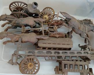 cast iron toy wagons with horses, they might be fire wagons / carriages