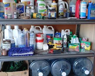 This shelving unit is filled with household chemicals, oils, cleaners, and gardening supplies. 