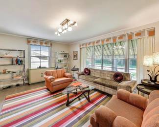 Sofa with pillows, coffee table and pair of chrome etageres are for sale.