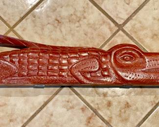 Mancala game from Ghana.  Carved crocodile with hinges opens to scoops to fill with stones or beans.  