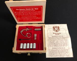Berloque Pistol.  Pistol shoots tiny cartridges.  On keychain.  