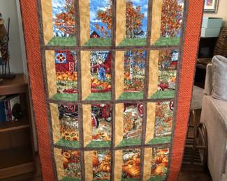 Beautiful hand quilted wall hanging.  It looks like you’re looking out of a window at a fall scene in the country.  