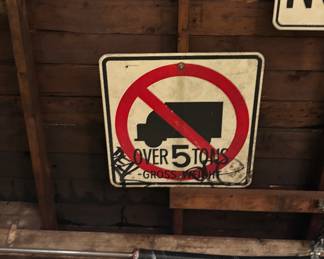 Graffiti tagged no trucks street sign