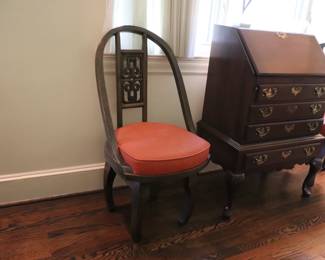 Pair of Chinese carved wood swivel chairs with curved legs, and mounted plaques at base.