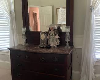 antique four drawer dresser with mirror, pair of glass lamps, china doll and clock