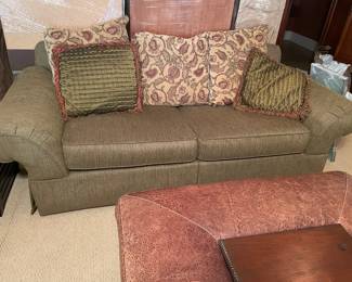 sofa with pillows, leather and wood coffee table/ ottoman