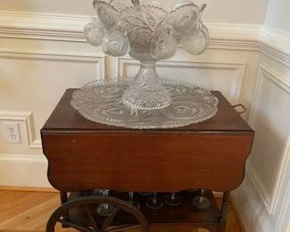 vintage drop leaf bar cart on wheels, pressed glass footed punch bowl and large pressed glass platter