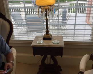 marble top table with harp base detail, two crystal figurines and Fenton lamp