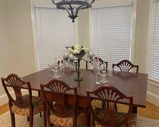 large drop leaf dining table, six chairs, small area rug, metal and crystal candelabra