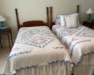 antique twin beds, blue and white glass lamps, Fenton bowl, pair of small one drawer night stands, hand made quilts