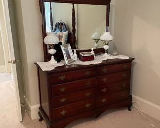 eight drawer dresser and mirror, two milk glass lamps and perfume bottles