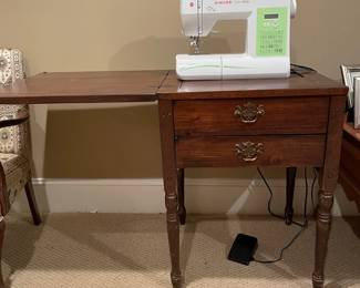 Wonderful like new sewing machine on a vintage sewing table