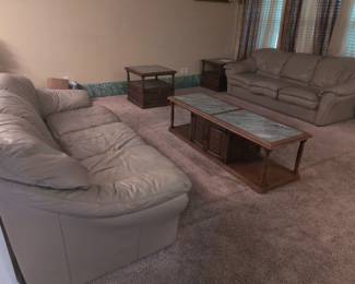 2 leather couches; wood coffee table and end table w/ marble inlay.